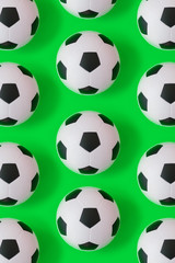 Naklejka premium Many black and white soccer balls background. Football balls in a water