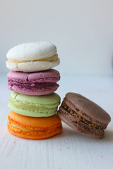 Colorful French or Italian macaroon stack cakes / Macaroon cakes. Assorted macaroon cakes stacked on top of each other on a light background. Copy space. Delicious dessert.