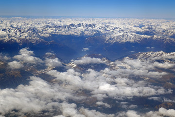 Fototapeta na wymiar Alps mountains in spring, Italy. Aerial view from air plane