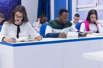 Fototapeta premium University mixed race Students, african, american and european during the class. Resolving problems together. Team work, multiethnic and happyness concept .