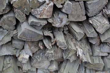Dry firewood for firing and heating lie in a pile in the backyard