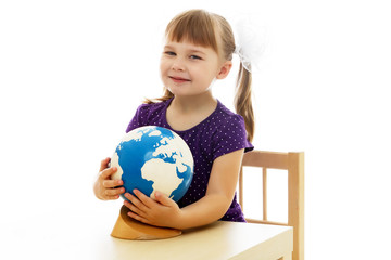 A little girl looks at the Globe.