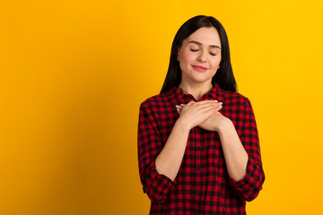 Closeup photo beautiful her she lady long hair sweet hold hands hands close heart chest full of emotions emotions wear specifications casual red shirt isolated yellow background