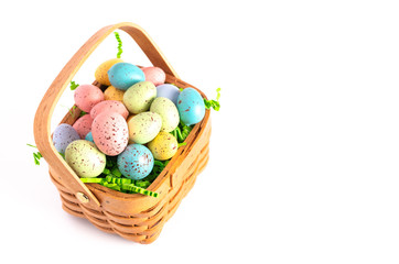 Easter Basket Filled with Decorated Eggs Isolated on a White Background