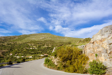 Asphalt road on west coast of Crete on a sunny spring day. Greece, Europe
