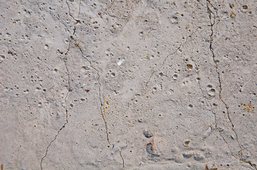 Gray concrete textures background. Cracks. Scratches. Damage. Cracked stone wall background.