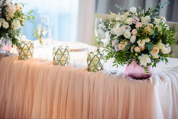 Beautiful festive decor. Table is decorated with bouquets of flowers and candles