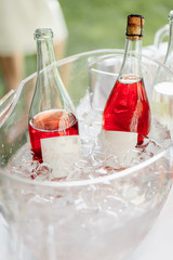 Buffet. Bottles with red sparkling wine lying in the ice, outdoors