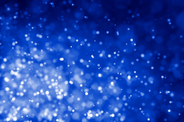 Glitter lights abstract blue background. Defocused bokeh illustration