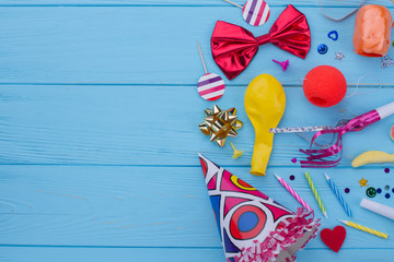 Birthday party items and accessories. Carnival or Birthday party supplies on blue wood with text...