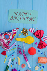 Happy Birthday card and party accessories. Birthday party background with colorful supplies, top view.