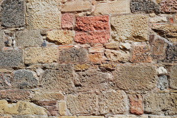 Wall of stones close-up with different colors and shades. For design, background and textures.