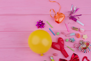Carnival or Birthday party items with copy space. Colorful Birthday party background with balloons, blowers, candles, candies and other accessories.