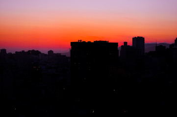 Obraz na płótnie Canvas Urban city with tall buildings and sunset