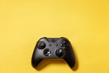 Black joystick gamepad, game console on yellow colourful trendy modern fashion pin-up background....