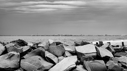 boulders overlooking a city on the other side of the bay