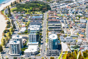 View from top of Mount Maunganui to streets and apartment  buildings below