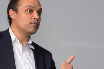 African american business coach gives presentation for business people, multiracial and multiethnic business peoople at conference meeting room.