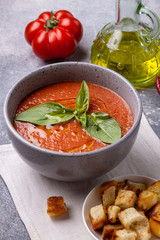 Traditional Spanish gazpacho and croutons on table. Vegan cold tomato soup