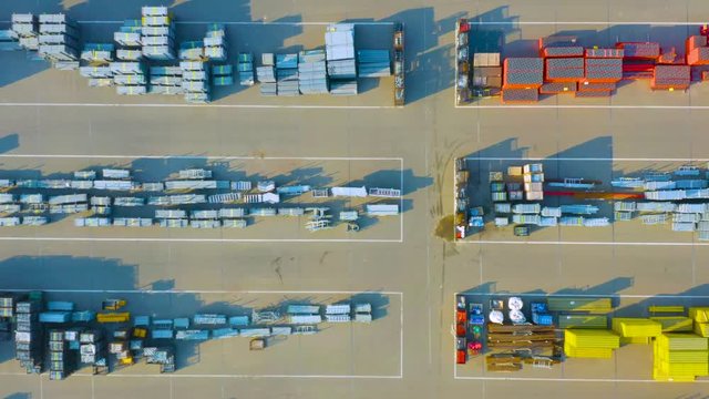 Aerial top view of the outside storage (storage yard) of a modern bright structural and  building materials on a sunny day