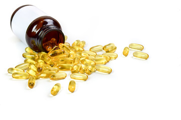 close up of gold fish oil capsules with pills isolated on white background. Omega 3. Vitamin E. Supplementary food background. Capsules salmon fish view.