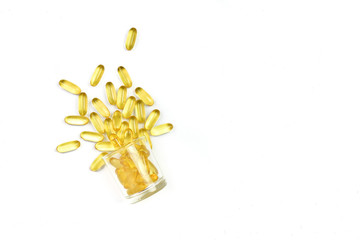 Close up of gold pile fish oil capsules isolated on white background. Omega 3. Vitamin E. Supplementary food background. Capsules salmon fish oil. Copy space.