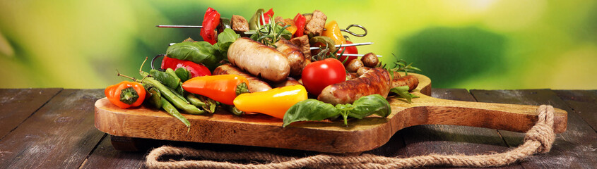 Assorted delicious grilled meat with vegetable on a barbecue. Grilled pork shish or kebab on skewers with vegetables . Food background shashlik