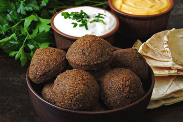 Fresh falafel balls, pita, sauce and herbs. Vegan falafel. Middle Eastern cuisine.