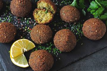 Fresh falafel balls, spices, sauce and herbs. Vegan falafel. Healthy lean food. Middle Eastern cuisine.