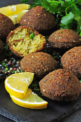 Fresh falafel balls, spices, sauce and herbs. Vegan falafel. Healthy lean food. Middle Eastern cuisine.