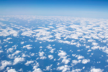 Blue sky with clouds view from the airplane porthole