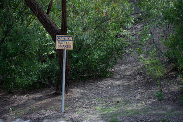 Rattlesnake warning/caution sign at park in West Hills, Los Angeles, California