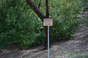 Rattlesnake warning/caution sign at park in West Hills, Los Angeles, California
