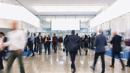 trade fair visitors walking in a clean futuristic corridor, copy space for individual text 