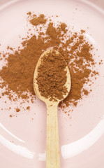 Top view of cosmetic clay powder in a wooden spoon