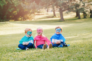 Cute preschool Caucasian children playing superheroes. Three kids friends having fun together...