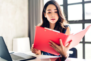 Fototapeta premium Businesswoman sitting and working with laptop computer.creative business people planning in her workstation at modern work loft