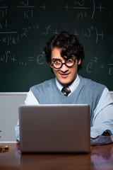 Young math teacher in front of chalkboard