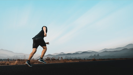 Young man enjoy running outside with beautiful summer evening in the countryside.