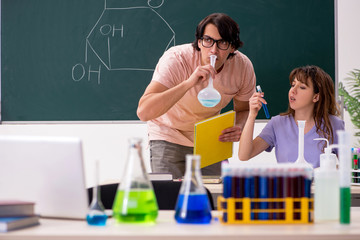 Two chemists students in classroom 