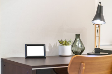 Empty picture frame placed on the desk in the bedroom