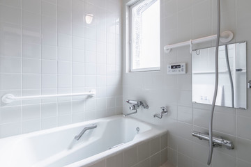 Fototapeta na wymiar Large white bathtub in new modern bathroom