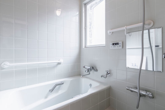 Large white bathtub in new modern bathroom