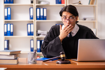 Young handsome judge working in court 