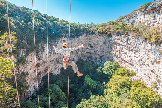 Woman rappelling at the amazing Sima de las Cotorras sinkhole, located in Chiapas Mexico