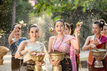 Vientiane Laos APRIL 4 2019 : Young happy beauty Asian woman splashing water during  Water Songkran...