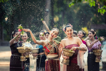 Vientiane Laos APRIL 4 2019 : Young happy beauty Asian woman splashing water during  Water Songkran festival ,Thailand Laos traditional.