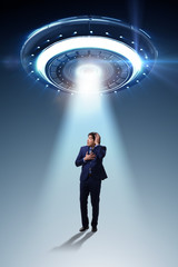 Flying saucer abducting young businessman 