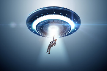 Flying saucer abducting young businessman 