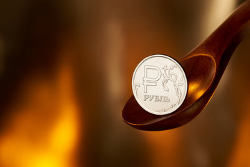 Rubles on spoon and fire background